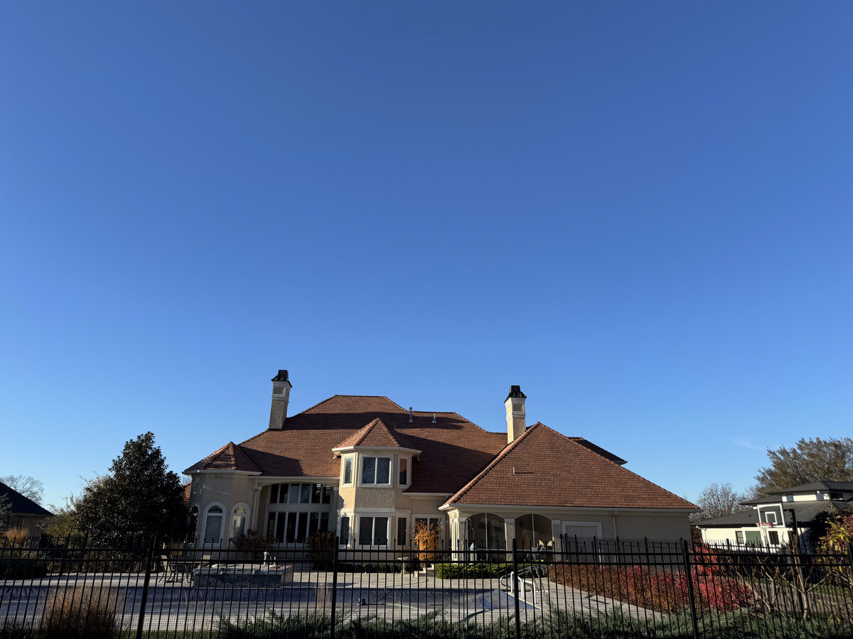 Mansion behind iron gate with premium tile roof