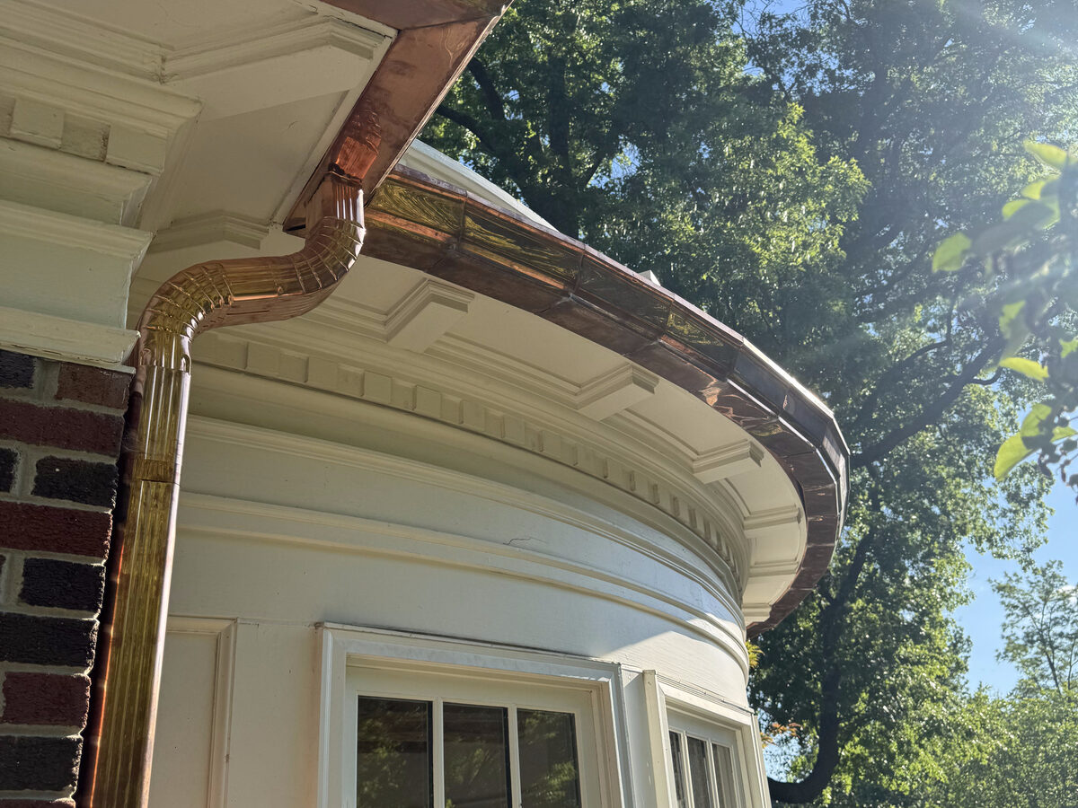 Curved copper gutter detail on bay window