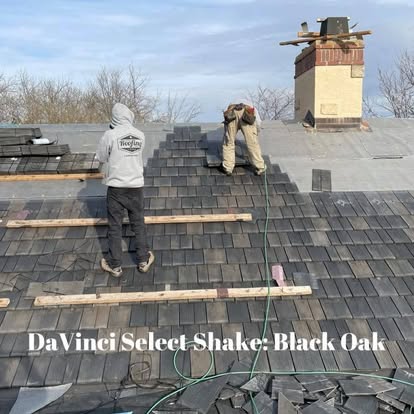 Crew installing DaVinci shake on rooftop with chimney
